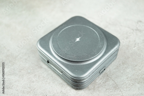 Wireless battery charger isolated on gray background