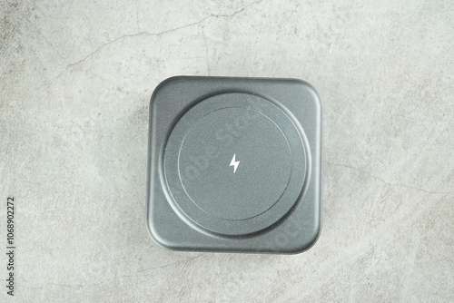 Wireless battery charger isolated on gray background