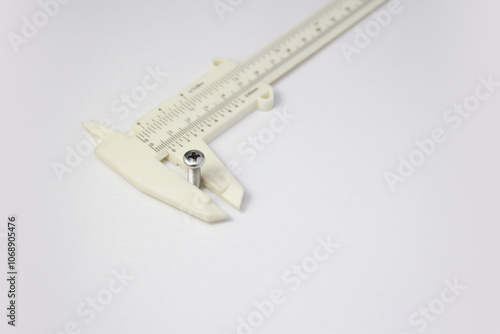 Measuring screw thread diameter with a vernier caliper photo