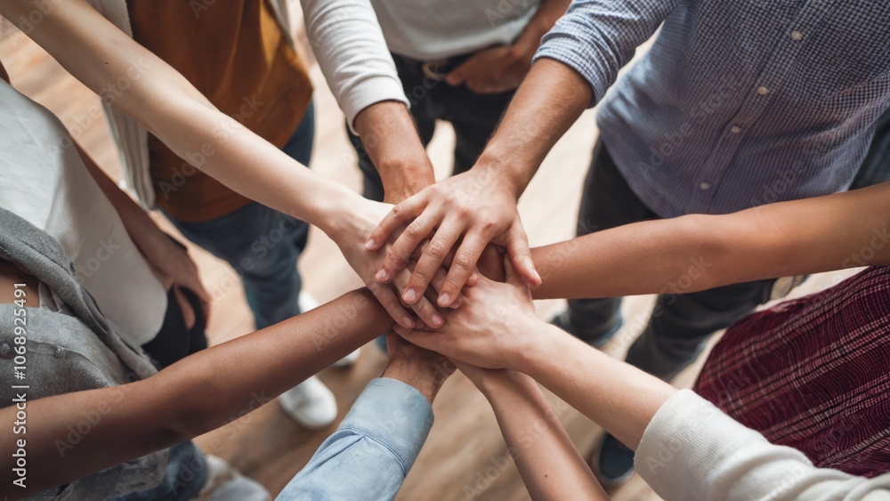 A group of people are holding hands in a circle. Concept of unity and togetherness A group of people are holding hands in a circle. Concept of unity and togetherness