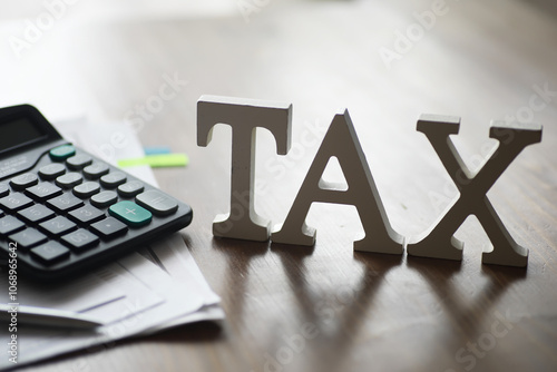 Fotografi Tax Preparation Concept with Calculator and Documents on Wooden Desk