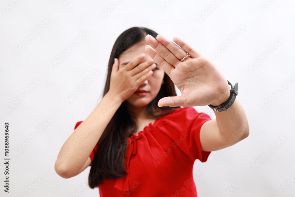 Young hispanic woman wearing casual red shirt covering eyes with hands and doing stop gesture with sad and fear expression. embarrassed and negative concept. Young hispanic woman wearing casual red shirt covering eyes with hands and doing stop gesture with sad and fear expression. embarrassed and negative concept.