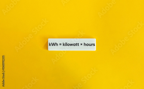 kWh Equation. Text on Block Letter Tile on Yellow Background. photo