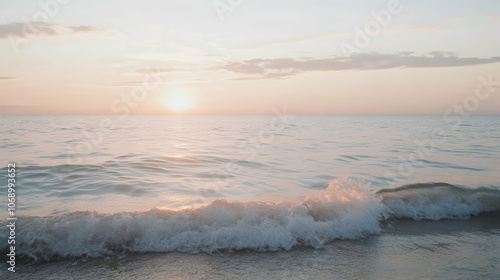 Calm ocean waves crashing on the shore at sunset.