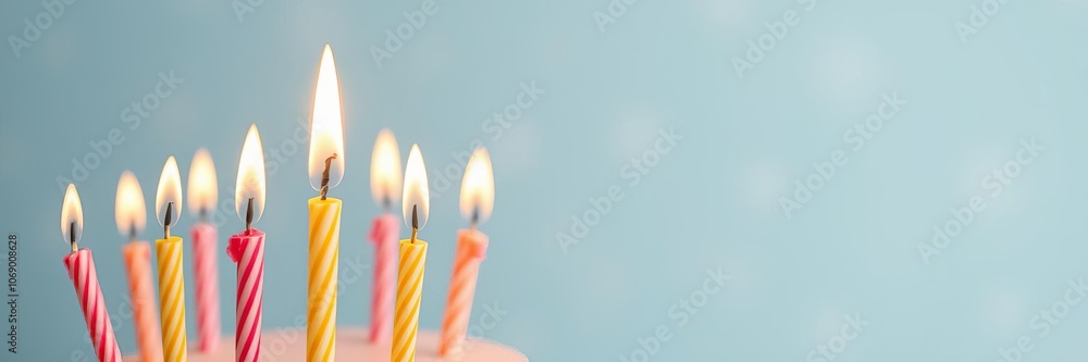 A bright yellow background with a single birthday candle in the center, ready to be lit for a celebration, one, birthday candle A bright yellow background with a single birthday candle in the center, ready to be lit for a celebration, one, birthday candle