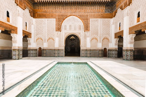 Ben youssef madrasa courtyard with intricate tile mosaics and water pool in marrakech, morocco, traditional islamic architecture design in an historic and famous destination, cultural landmark