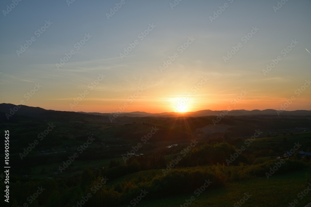 The sunset and its rays dazzle the green forests and meadows The sunset and its rays dazzle the green forests and meadows