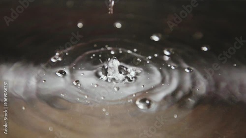 drops of water on a sink full of water.