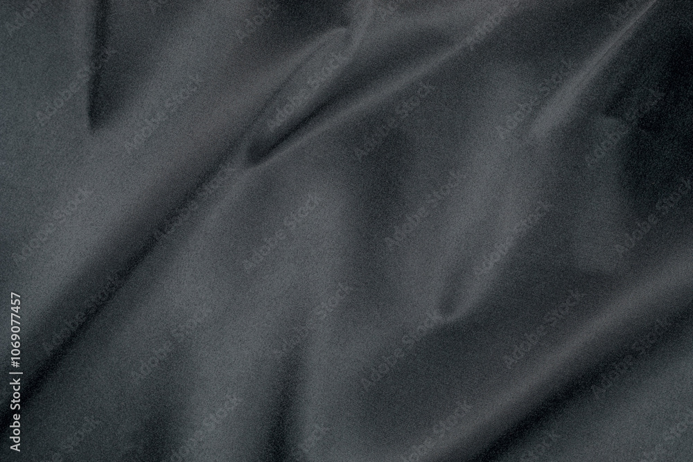 Fototapeta premium Black fabric features a smooth, soft texture with gentle draping and a subtle sheen, perfect for dark background