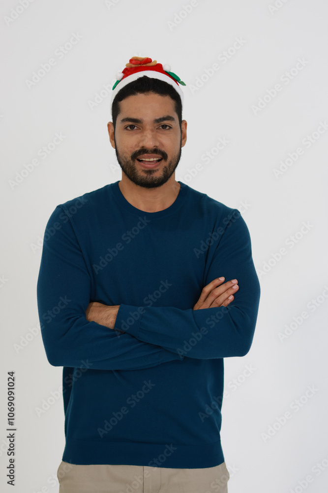A smiling smart man wearing a Santa hat celebrating Christmas against a white background A smiling smart man wearing a Santa hat celebrating Christmas against a white background