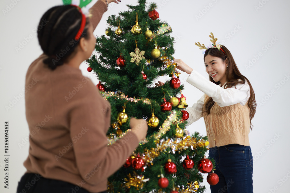 Group young diverse friends decorating the Christmas tree with smiles and holiday cheer Group young diverse friends decorating the Christmas tree with smiles and holiday cheer