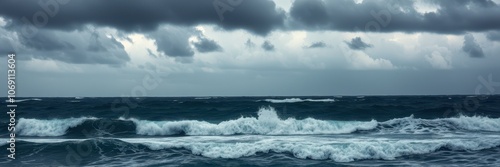 The ocean churns under a cloudy sky, with waves crashing against the shore