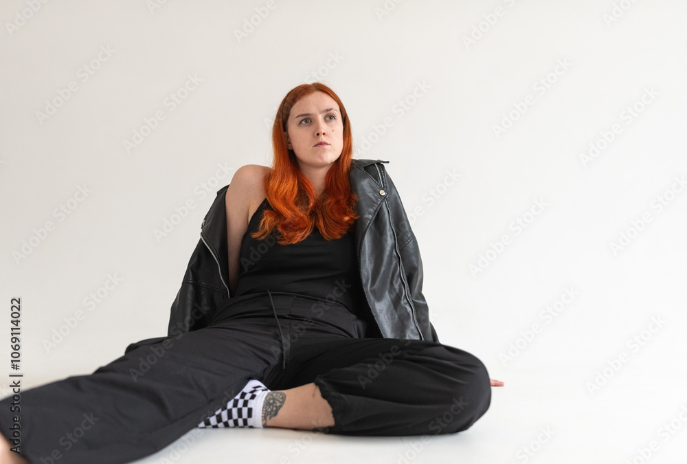 Studio portrait of a young beautiful red-haired girl. Studio portrait of a young beautiful red-haired girl.
