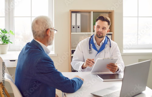 Elderly man visits rehabilitation doctor for consultation. Elderly man finds reassurance in doctor's rehabilitologist expertise hopeful improved well-being rehabilitation Elderly man visiting doctor photo