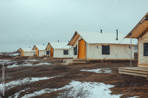 Selective focus luxury camping tent in tundra in north pole, Landscape view of camping zone with snowfall on the ground, Camping tent in winter in temperate zone. photo