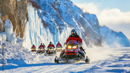 Fototapeta Naklejka Na Ścianę i Meble -  Tourists riding snowmobiles on frozen lake near icy cliff in winter