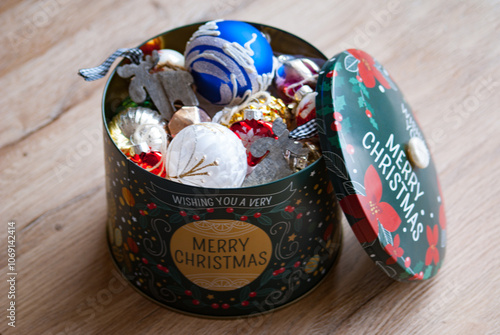 Old Christmas decorations and toys in green box. Storage of Christmas tree decorations.