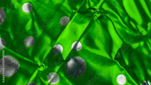 crumpled aluminum foil painted green with silver circles.