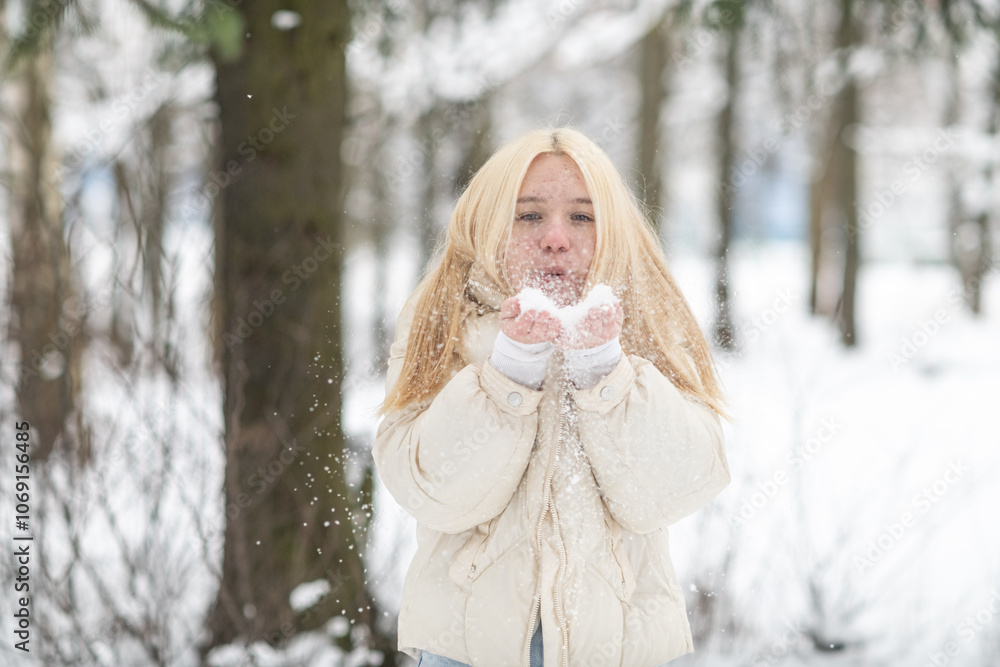Obraz premium Portrait of young beautiful blonde girl outdoors in winter.
