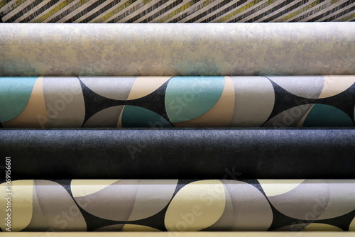 Rolls of vinyl wallpaper in building supermarket, store, market. Dense gray, beige, Green, purple wallpaper photo