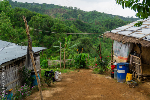 Adivasi homesteads on either side of the Bandarban hilly road. Tribal accommodation. Bandarban hill region is a tourist spot in Bangladesh.  photo