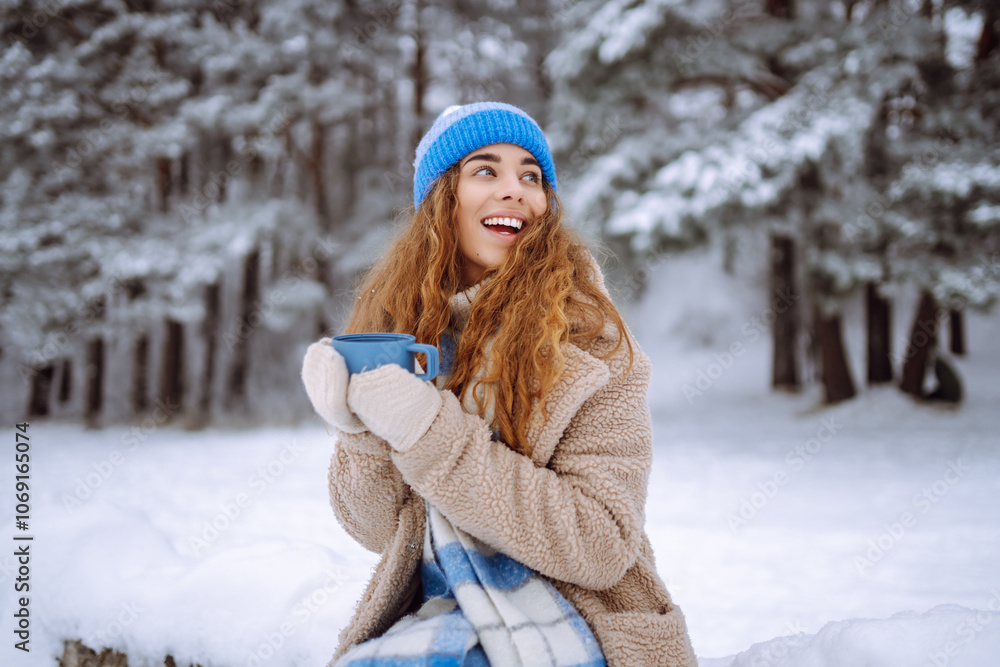 Beautiful woman is drinking a hot drink from a cup in the winter in nature. Winter forest. Travel, tourism, nature, active lifestyle. Beautiful woman is drinking a hot drink from a cup in the winter in nature. Winter forest. Travel, tourism, nature, active lifestyle.