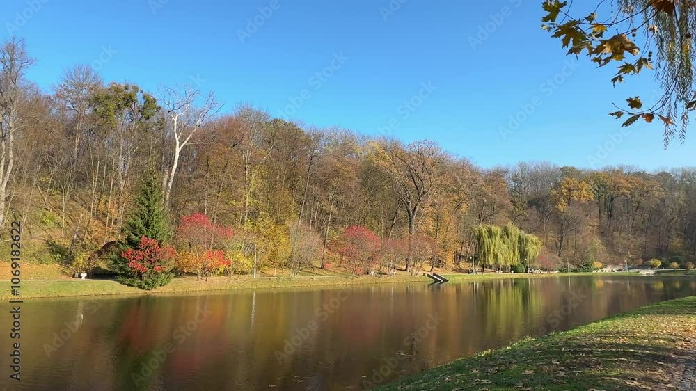 Autumn landscape with lake and trees in scenic park. Autumn landscape with lake and trees in scenic park.