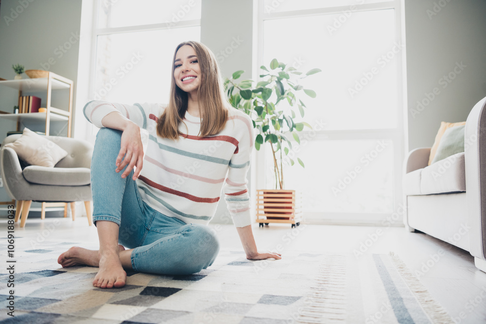 Joyful young woman enjoying leisure time at home in bright and airy living room, embracing relaxation and natural light Joyful young woman enjoying leisure time at home in bright and airy living room, embracing relaxation and natural light