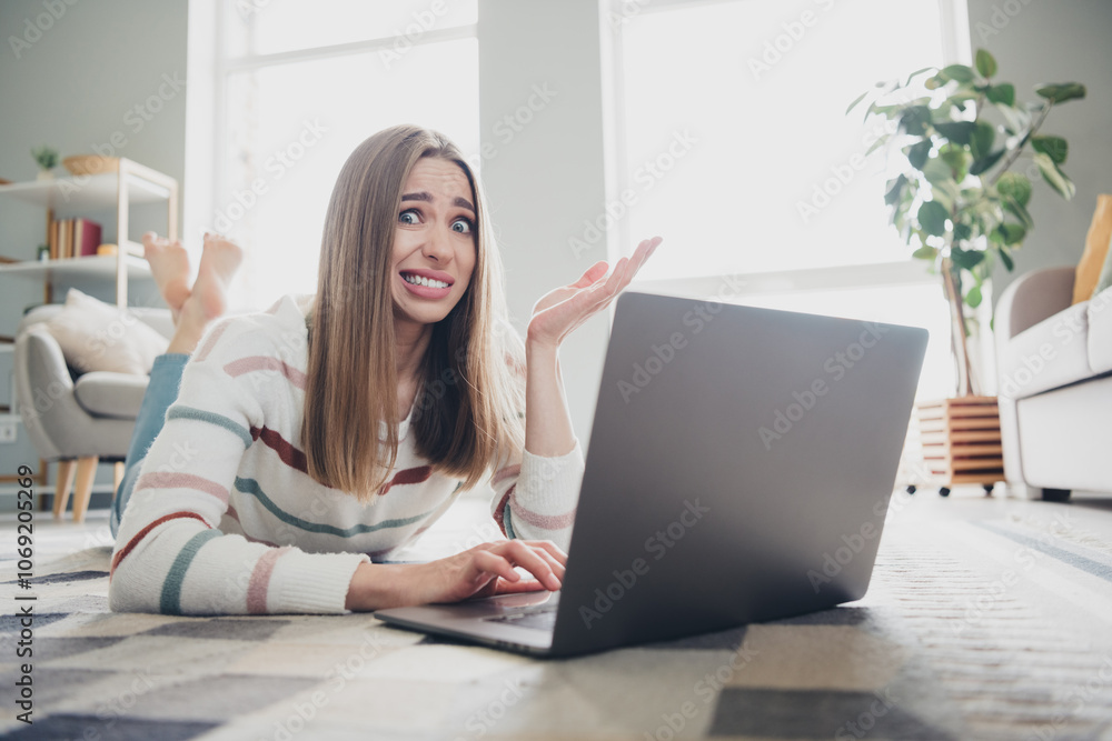 Young woman enjoying a relaxing moment at home with her laptop, smiling in natural daylight Young woman enjoying a relaxing moment at home with her laptop, smiling in natural daylight