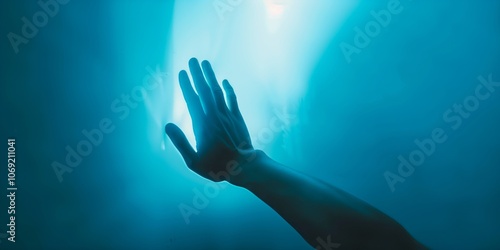 Abstract background with silhouette of a hand and light blue shades, blurred texture, light style.