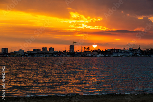 Dramatic Sunset Colors Over the Coast with Silhouetted Landmarks