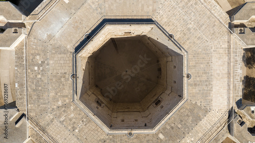 Aerial perpendicular view of Castel del Monte. It is a castle situated on a hill near Andria in the Apulia region, Italy. It is a fortress built in the Middle Ages and famous for its octagonal plan.