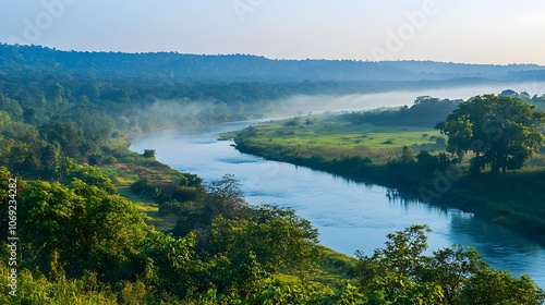 Quiet river meandering through a lush valley, with early morning mist gently rising from the water. The tranquil scene captures the serene beauty of nature in its peaceful, undisturbed state. photo