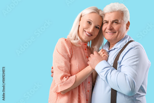 Happy mature couple on blue...