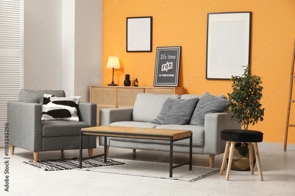 Cozy sofa, armchair and coffee table in interior of living room Cozy sofa, armchair and coffee table in interior of living room