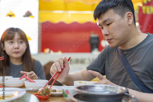 Photography Chinese Malaysian couple in their 32s enjoying meal at famous bak kut teh shop popular with locals in Kuala Lumpur, Malaysia