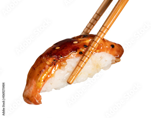 Foto Chopsticks holding grilled eel sushi with teriyaki sauce and sesame seeds, isola