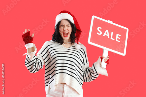 Happy young woman in Santa ...