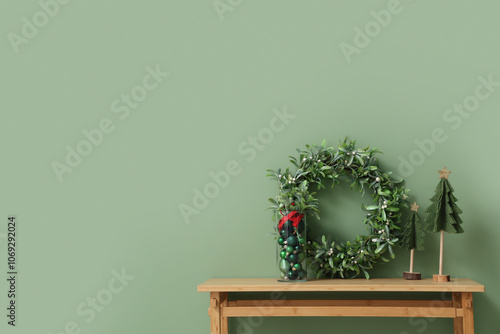 Wallpaper Mural Bench with mistletoe wreath, box of Christmas balls and fir tree near green wall in room Torontodigital.ca
