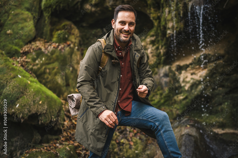 portrait of man hiker walk around waterfall and cave portrait of man hiker walk around waterfall and cave