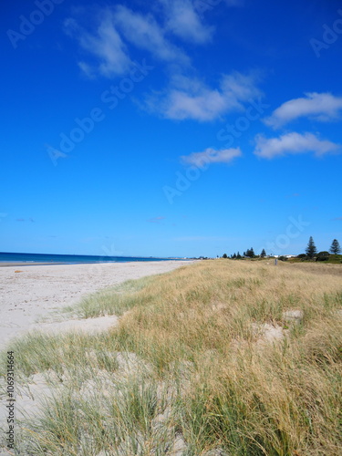 empty beach with blue sky and white sand