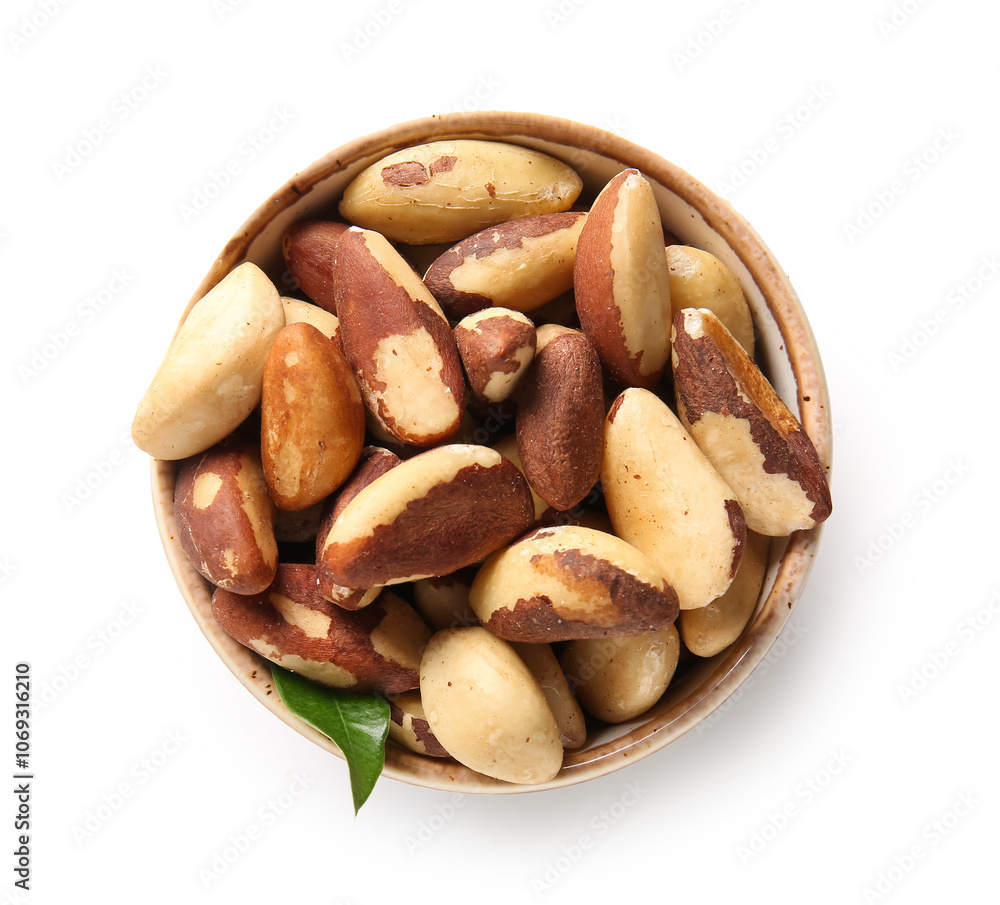 Bowl with tasty Brazil nuts on white background Bowl with tasty Brazil nuts on white background