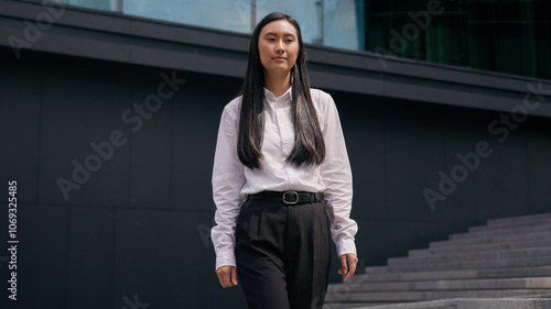 Confident Asian Korean woman businesswoman going steps walking successful business female entrepreneur leader boss ceo lawyer manager girl smile employer downtown outdoors city professional worker job