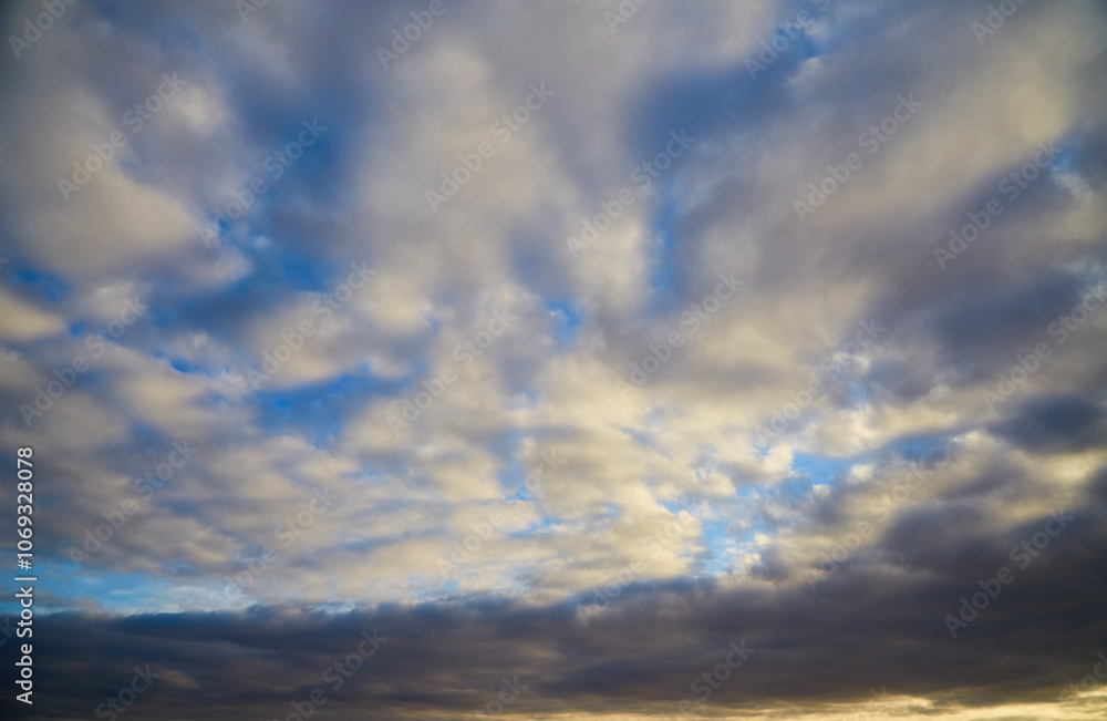 White clouds in the daytime blue sky with an approaching storm front, changing weather, heavenly background, celestial landscape. White clouds in the daytime blue sky with an approaching storm front, changing weather, heavenly background, celestial landscape.