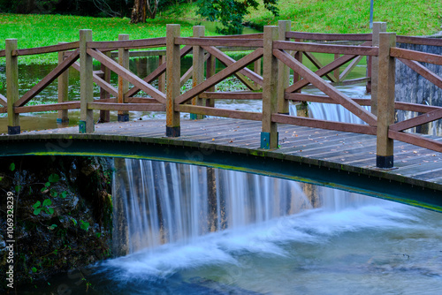 Wooden bridge over cascading water in Saja River, Cantabria, Spain.