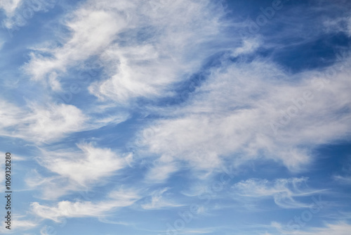 Fluffy white clouds in the afternoon blue sky, celestial background, celestial landscape.