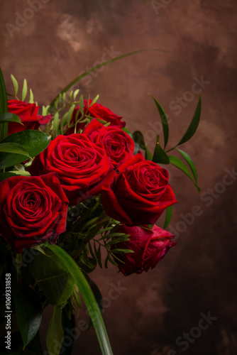 View of a bouquet of red roses, dark background, vertical, with copy space