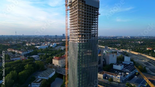 Berlin Estrel tower under construction. Dramatic aerial view flight drone photo