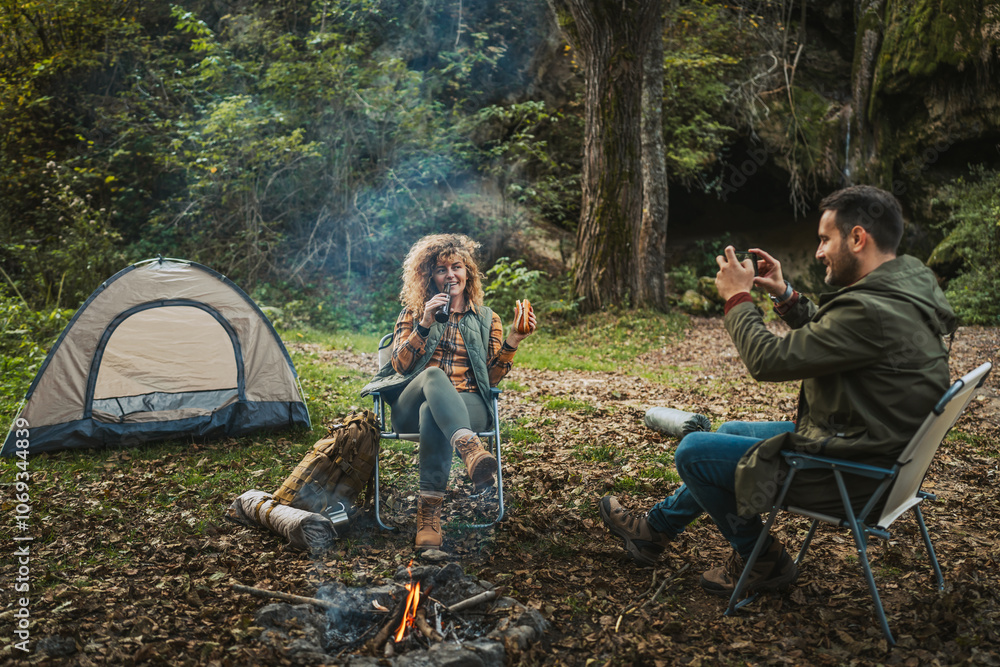 husband take a photo of his wife while enjoy in front tent husband take a photo of his wife while enjoy in front tent