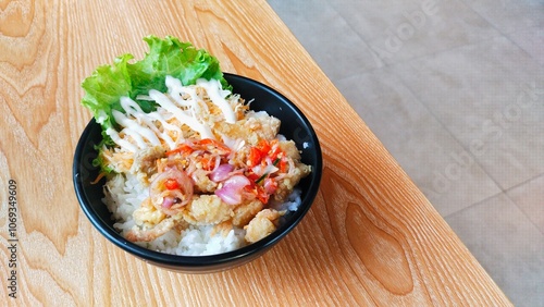 chicken rice bowls with sambal matah, looks tempting on the wooden table photo